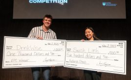 Elevator Pitch winners Owen Works and Camille Boiteux holding their $1,000 and $500 awarded checks.